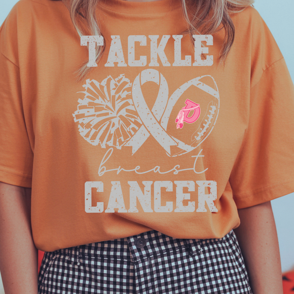 Person wearing an orange t-shirt with 'Tackle Breast Cancer' design, standing against a blurred background.