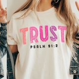 A 3x3 collage showing a woman wearing different printed white T-shirts. Each shirt features a colorful inspirational Bible verse or quote design, including references to Chosen, Trust, His Way Is Better, Jesus Made Me A Teacher, Psalm 23 Shepherd, and other verses.