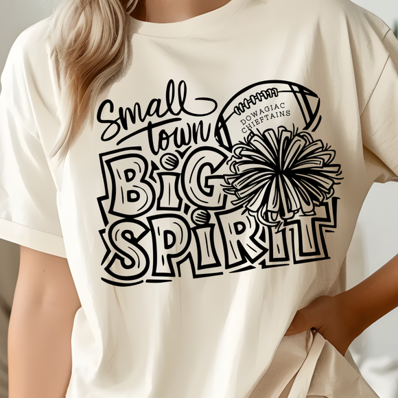 Person wearing a cream t-shirt with 'Small Town Big Spirit' text and graphic design.