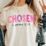 A 3x3 collage showing a woman wearing different printed white T-shirts. Each shirt features a colorful inspirational Bible verse or quote design, including references to Chosen, Trust, His Way Is Better, Jesus Made Me A Teacher, Psalm 23 Shepherd, and other verses.