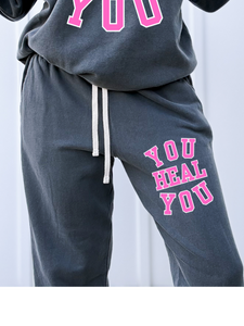 Gray sweatshirt and pants set with 'YOU HEAL YOU' text in pink on a white background