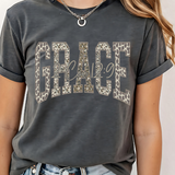A 3x3 collage showing nine different color and style options of a graphic t-shirt. The shirts feature phrases like 'ain't no ghost like the holy ghost' and 'JESUS Not Coffee' with various graphic designs, shown on models wearing jeans.