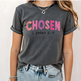 A 3x3 grid showing nine women wearing dark gray graphic t-shirts with different inspirational and religious designs, paired with light wash denim jeans.