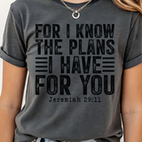 A 3x3 grid showing nine women modeling the same dark gray graphic T-shirt with different colorful text and design prints. The shirts feature phrases such as 'CHOSEN', 'TRUST', 'HIS NAVY IS BETTER', 'BIBLE PLANS HAVE TO BE RIGHT', 'PSALM 23 SHEEPHERD', and others with religious-themed graphics.