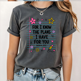 A 3x3 grid showing nine women modeling the same dark gray graphic T-shirt with different colorful text and design prints. The shirts feature phrases such as 'CHOSEN', 'TRUST', 'HIS NAVY IS BETTER', 'BIBLE PLANS HAVE TO BE RIGHT', 'PSALM 23 SHEEPHERD', and others with religious-themed graphics.