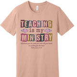 A 3x3 grid showing nine peach-colored short-sleeve t-shirts, each with a different colorful teacher-themed graphic design such as an apple, lightning bolt, and text slogans.