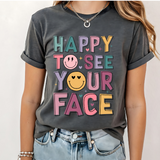 A 3x3 grid showing nine different dark gray graphic t-shirts modeled on a person. The shirts feature various colorful and white inspirational Christian-themed designs including 'HAPPY TO SEE YOUR FACE', 'TEACHER YOU ARE', 'AMEN TEACHERS', and 'JESUS'.