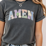 A 3x3 grid showing nine different dark gray graphic t-shirts modeled on a person. The shirts feature various colorful and white inspirational Christian-themed designs including 'HAPPY TO SEE YOUR FACE', 'TEACHER YOU ARE', 'AMEN TEACHERS', and 'JESUS'.