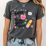 A 3x3 grid showing nine different dark gray graphic t-shirts modeled on a person. The shirts feature various colorful and white inspirational Christian-themed designs including 'HAPPY TO SEE YOUR FACE', 'TEACHER YOU ARE', 'AMEN TEACHERS', and 'JESUS'.