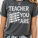 A 3x3 grid showing nine different dark gray graphic t-shirts modeled on a person. The shirts feature various colorful and white inspirational Christian-themed designs including 'HAPPY TO SEE YOUR FACE', 'TEACHER YOU ARE', 'AMEN TEACHERS', and 'JESUS'.