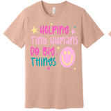 A 3x3 grid showing nine short-sleeve crew-neck T-shirts in a light peach-beige color, each with a different teacher-themed graphic print on the front, displayed against a plain white background.
