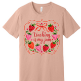 A 3x3 grid showing nine short-sleeve crew-neck T-shirts in a light peach-beige color, each with a different teacher-themed graphic print on the front, displayed against a plain white background.