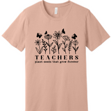 A 3x3 grid showing nine short-sleeve crew-neck T-shirts in a light peach-beige color, each with a different teacher-themed graphic print on the front, displayed against a plain white background.