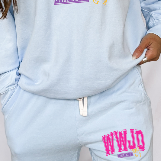 Light blue sweatshirt and pants with 'WWJD' text on a plain background