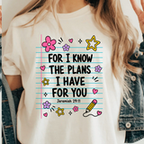 A 3x3 collage showing a woman wearing different printed white T-shirts. Each shirt features a colorful inspirational Bible verse or quote design, including references to Chosen, Trust, His Way Is Better, Jesus Made Me A Teacher, Psalm 23 Shepherd, and other verses.
