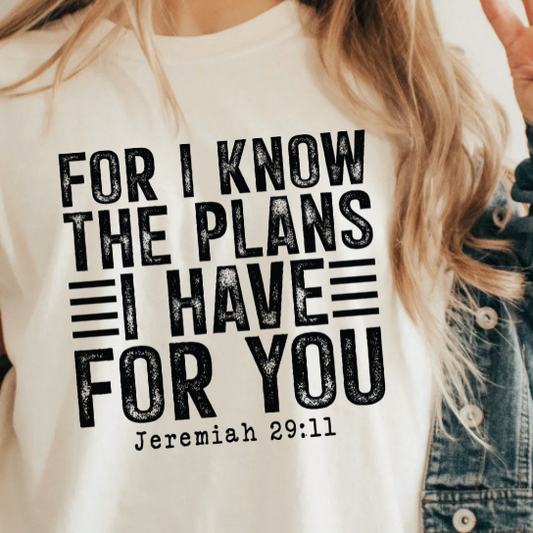 A 3x3 collage showing a woman wearing different printed white T-shirts. Each shirt features a colorful inspirational Bible verse or quote design, including references to Chosen, Trust, His Way Is Better, Jesus Made Me A Teacher, Psalm 23 Shepherd, and other verses.